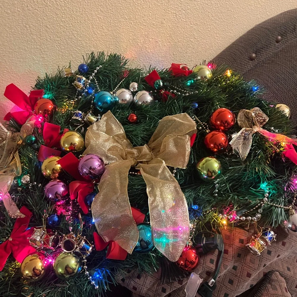 Festive Holiday Wreath with Gold Bow and Multicolor Ornaments